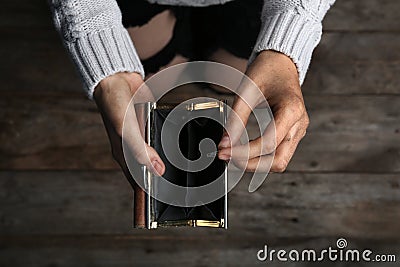 Poor woman holding empty wallet and coin Stock Photo