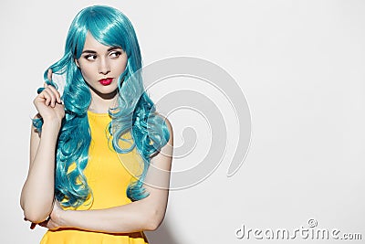 Pop art woman portrait wearing blue curly wig Stock Photo