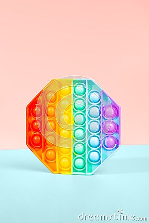 Pop it toy for children. rainbow octahedron on pink background. antistress toy Stock Photo