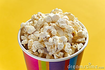 Popcorn in papercup against yellow background Stock Photo