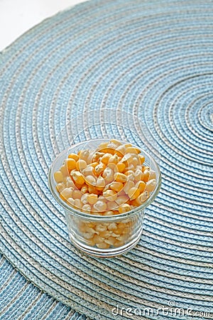 Popcorn seeds in a glass cup portrait side Stock Photo