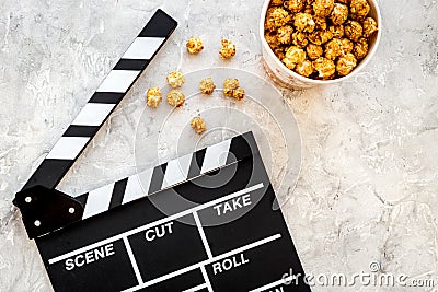 Popcorn for watching fim near clapperboard on grey background top view copyspace Stock Photo