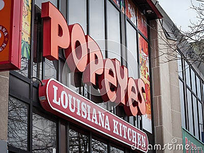 Popeyes Louisiana Restaurant logo in front of their local restaurant in Toronto, Ontario. Editorial Stock Photo