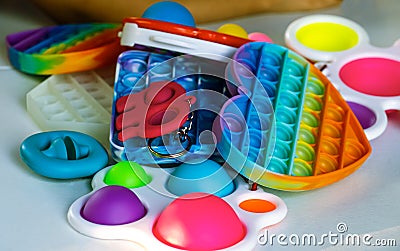 Popit and simple dimple toys on white table. Closeup. Stock Photo