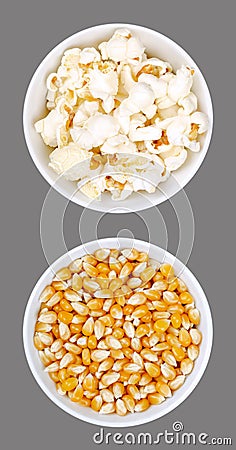 Popped and unpopped popcorn, in white bowls, on gray background Stock Photo