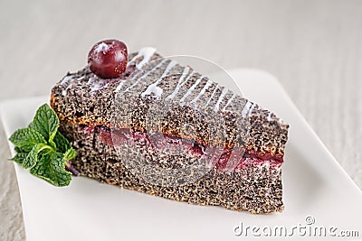 Poppy cream cake with white topping and cherry on top, product photography for patisserie Stock Photo