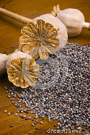 Poppy seeds on wooden table Stock Photo