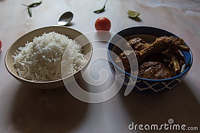 Popular Bengali lunch menu white rice and chicken masala. Stock Photo