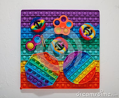 Popular colorful children`s toys Spinner, Simple dimple, Pop it and Snapperz toy Top view Stock Photo