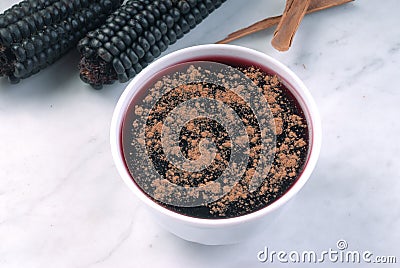 Peruvian dessert called mazamorra morada the main ingredient purple corn visible in the back Stock Photo