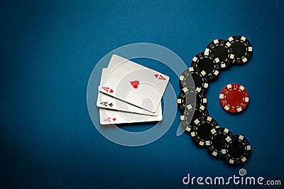 A popular poker game with a combination of three of a kind or set. Chips and cards on a blue table in a poker club. Advertising Stock Photo