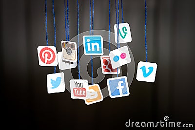 Popular social media website logos printed on paper and hanging Editorial Stock Photo