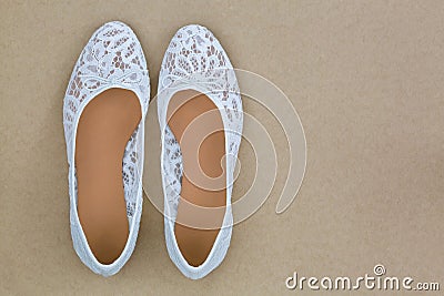 Popular white floral lace ballet flat slip on shoes on brown bac Stock Photo