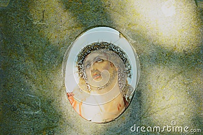 Porcelain Jesus tile on historic grave Stock Photo