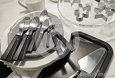 Porcelain Plates, Coffee Cup, Silverware and Cookie Cutters Stock Photo