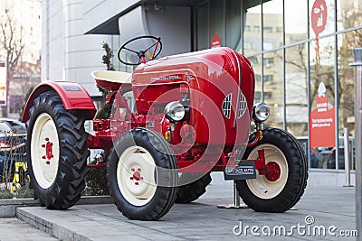 Porsche Junior tractor parked in front of a hotel Editorial Stock Photo