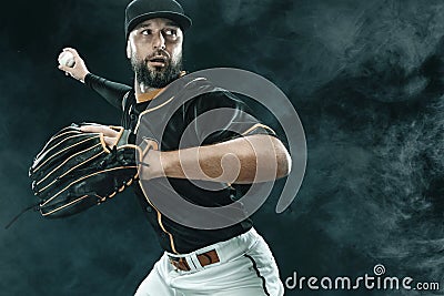 Baseball player with ball. Ballplayer on black background. Stock Photo