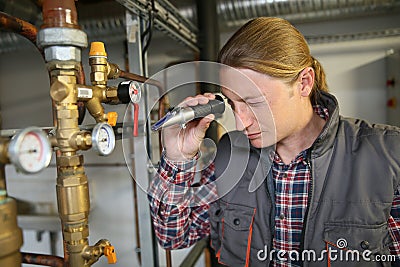 Porfessional plumber controling water quality from heater Stock Photo