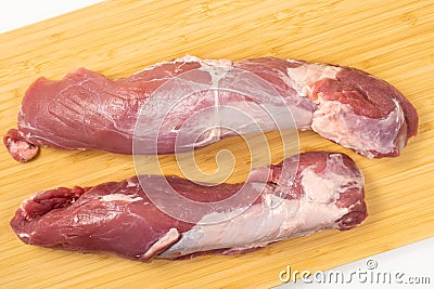 Pork boneless loin or tenderloin on a cutting board, close up Stock Photo