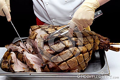 Pork. Chef cuts baked meat Stock Photo