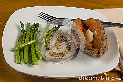 pork chop with sweet potato and sauteed asparagus Stock Photo