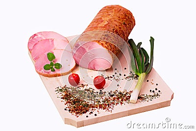 Pork ham with onion, tomatoes on a wooden plate Stock Photo