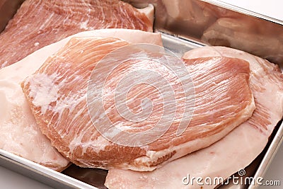 pork jowl meat in a butcher tray Stock Photo