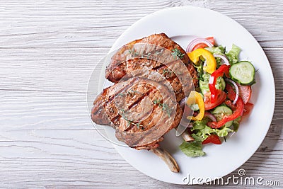 Pork meat grilled with fresh vegetable salad top view Stock Photo