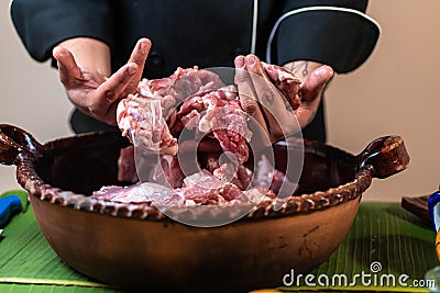 Pork meat preparation for cochinita tacos with Mexican chef Stock Photo