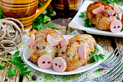Pork meatballs - baked cutlet with minced meat and rice in crispy chicken skin shaped funny pigs Stock Photo