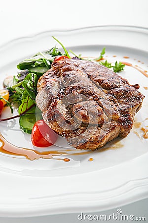 Pork Neck Steak with Mixed Salad on White Restaurent Plate Stock Photo