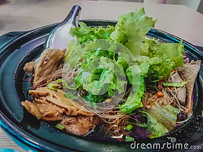 Pork noodles, stewed, boiled water in a clay bowl Stock Photo