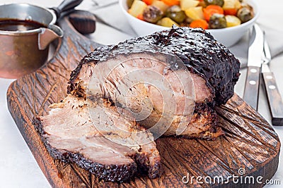 Pork shoulder in honey parmesan and soy souse, prepared in slow cooker or crockpot, on wooden board, horizontal Stock Photo