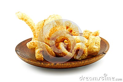 Pork snack or Pork scratching leather lean pork fried crispy and blistered in wood plate Stock Photo