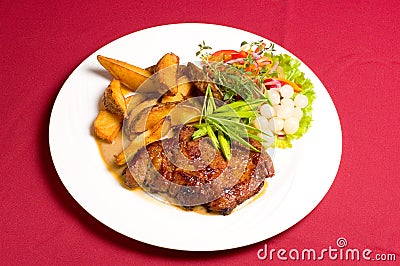 Pork steak with baked potatoes Stock Photo