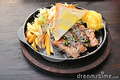 Pork steak with french fries and vegetables Stock Photo