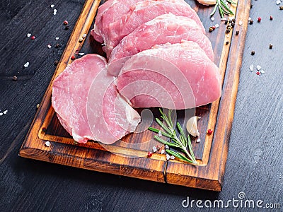 Pork steak, raw carbonate fillet on dark background, meat with r Stock Photo