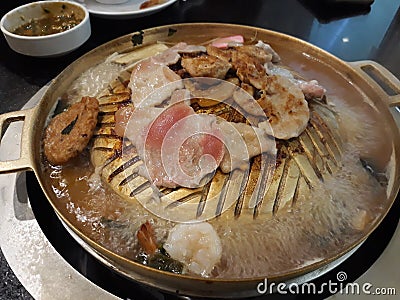 Pork and various meats bbq on a gold iron pan, Asian food concept. Stock Photo