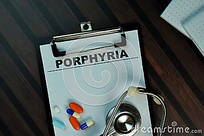 Porphyria write on a paperwork isolated on Wooden Table. Medical or Healthcare concept Stock Photo