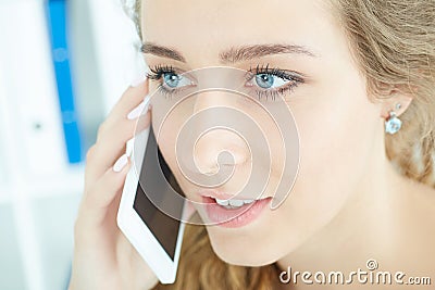 Porrait of a young business woman talking on the mobile phone in the office. Stock Photo