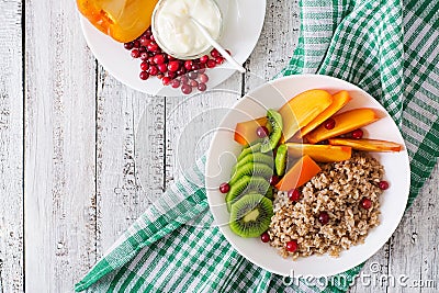 Porridge with fresh fruit and cranberries. Healthy breakfast. Stock Photo