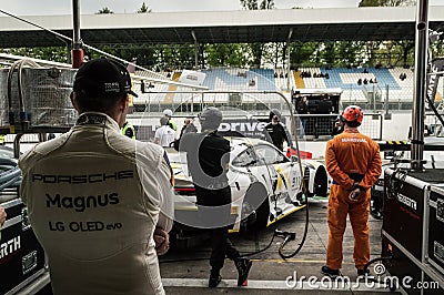 Porsche 911 RSR on jacks in the pits of Monza Editorial Stock Photo