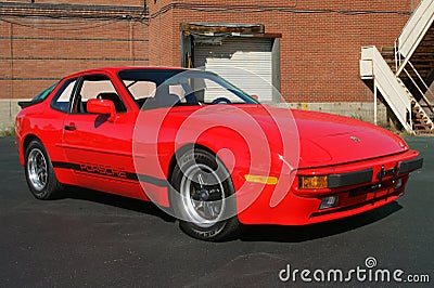 Porsche 944 in red in front of brick building Editorial Stock Photo