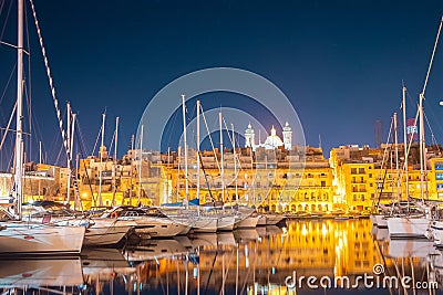 Port with boats and yachts on pier Valletta Malta Night view. Travel concept Stock Photo