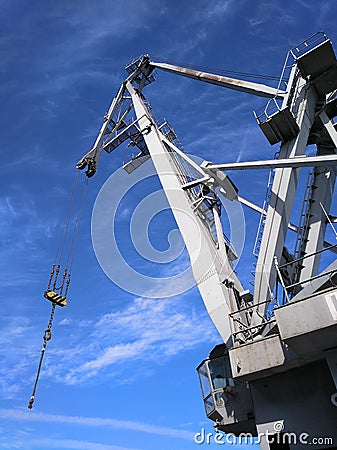 Port crane silhouette against deep blue sky Stock Photo