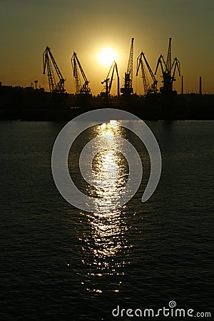 port derricks silhouette in a sunset Stock Photo