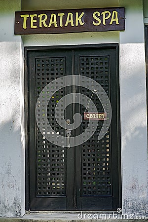 Closed wooden sign hanging on the door of a spa Editorial Stock Photo
