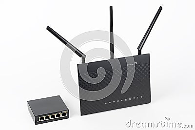 5-port gigabit desktop switch and dual-band gigabit Wi-Fi router. Components to create a fast computer network Stock Photo