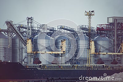 Port grain elevator. Industrial sea trading port bulk cargo zone grain terminal Stock Photo