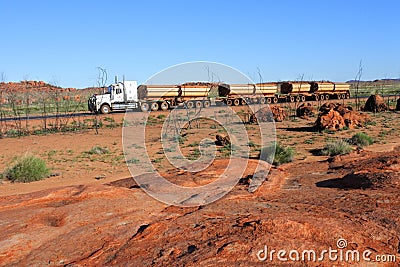 Four-trailer road train driving on Great Northern Highway and Newman Western Australia Editorial Stock Photo
